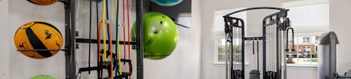 the fitness center with weights and a window