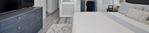 a bedroom with a large bed and a tv