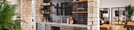 A modern kitchen with a brick wall and wooden floors.