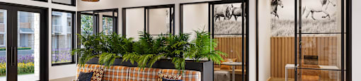 A room with a couch, plants, and a wooden floor.