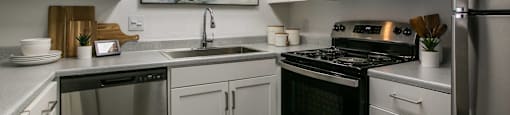 a kitchen with stainless steel appliances and white cabinets at AYA ABQ, New Mexico, 87109