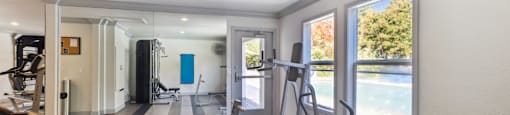 A well-equipped home gym with a variety of exercise equipment.