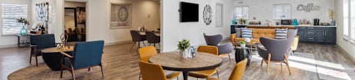 A modern dining room with a round table and chairs.