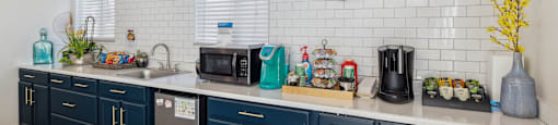 A kitchen with a coffee sign on the wall.