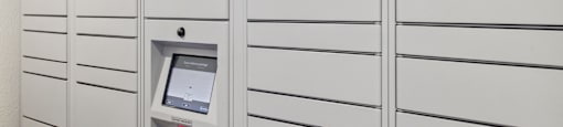 A row of white lockers with a hub logo on the first one.