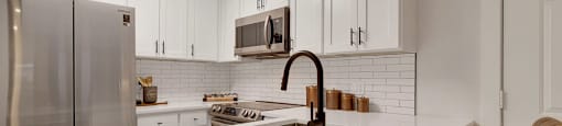 A kitchen with a white countertop and brown chairs.