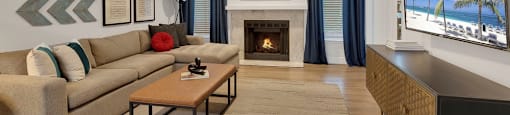 A living room with a fireplace and a flat screen TV.