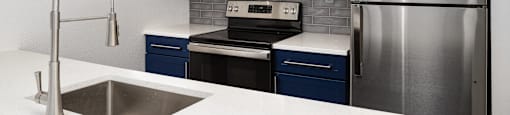 a kitchen with stainless steel appliances and a white counter top