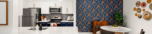 an open kitchen and dining room with a white counter top and a table and chairs