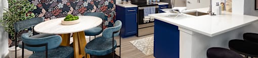 a kitchen with blue cabinets and a table and chairs