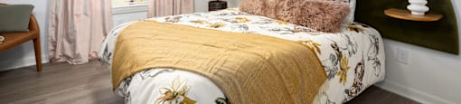 a bedroom with a bed with a green headboard