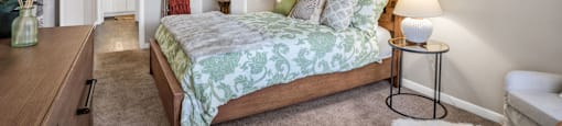a bedroom with a bed and a dresser  at Castilian Apartments, Orlando, FL