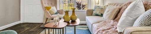 a living room with a white couch and a large window  at Castilian Apartments, Orlando, 32839