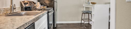 a kitchen with white cabinetry and stainless steel appliances  at Castilian Apartments, Florida