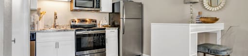 a kitchen with white cabinetry and stainless steel appliances  at Castilian Apartments, Orlando, FL