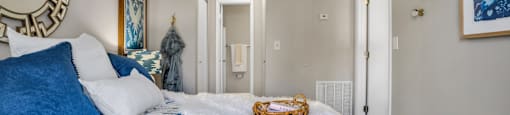 a bedroom with a bed and a mirror  at Castilian Apartments, Florida
