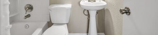 a bathroom with a sink toilet and bathtub  at Castilian Apartments, Orlando, FL