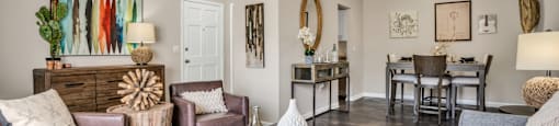 our apartments offer a living room with a couch a coffee table and a dining room table  at Castilian Apartments, Orlando, FL, 32839