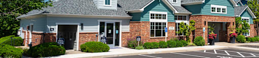 a large house with a parking lot in front of it