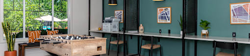 a games room with a foosball table and a bar