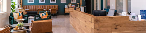 a lobby with a reception desk and chairs
