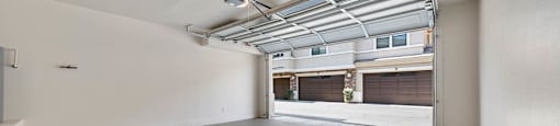 A large empty room with a concrete floor and white walls.