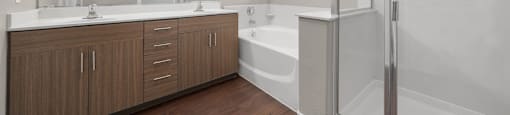 A modern bathroom with a white tub and wooden cabinets.