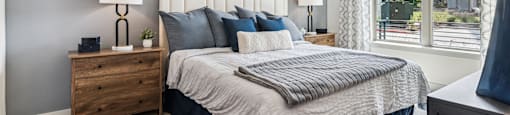 a bedroom with a large bed and a window