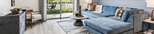 an open living room with a blue couch and a tv