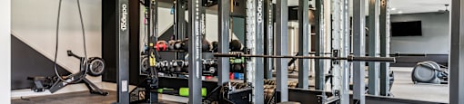 a home gym with weights machines and a tv