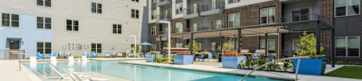 an apartment swimming pool in front of an apartment building