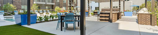 a patio with a table and chairs under awning