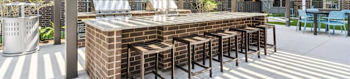 a large outdoor bar with chairs under awning