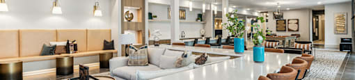 a living room with a long white communal table and chairs