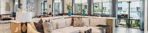 a living room with a large couch and a chandelier