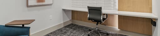 a small office area with a chair and a desk