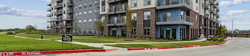 a large apartment building on the side of a road