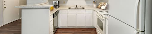the preserve at ballantyne commons apartment kitchen with white cabinets and appliances