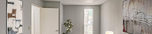 the master bedroom has a large bed and a sliding door to the living room