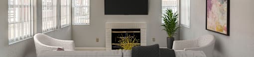 a living room with a white couch and a fireplace and a television