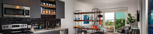 a kitchen and living room with a view of the ocean at Burano, Long Beach, CA 90802