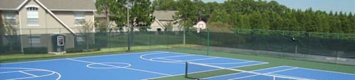 A tennis court with blue and green surface and white lines.