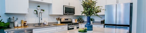 a kitchen with a large island and stainless steel appliancesat Townes at Peace Way, Las Vegas, NV 89147