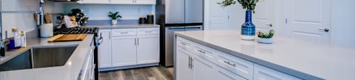 a kitchen with white cabinets and stainless steel appliancesat Townes at Peace Way, Nevada, 89147
