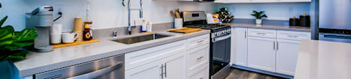 a kitchen with white cabinets and stainless steel appliancesat Townes at Peace Way, Nevada