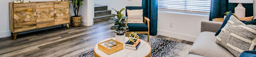 a living area with a couch coffee table and tvat Townes at Peace Way, Las Vegas, NV