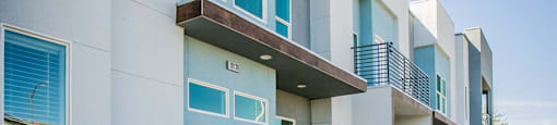 a picture of an apartment building with a sidewalk and landscapingat Townes at Peace Way, Las Vegas Nevada