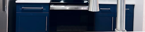 a kitchen with white cabinets and black appliances and a sink