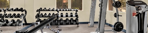 a gym with weights and other exercise equipment in a building