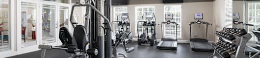 A well-equipped gym with a variety of machines and weightlifting equipment.